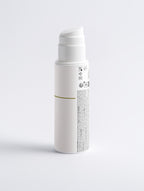 White cylindrical container with text on a light gray background
